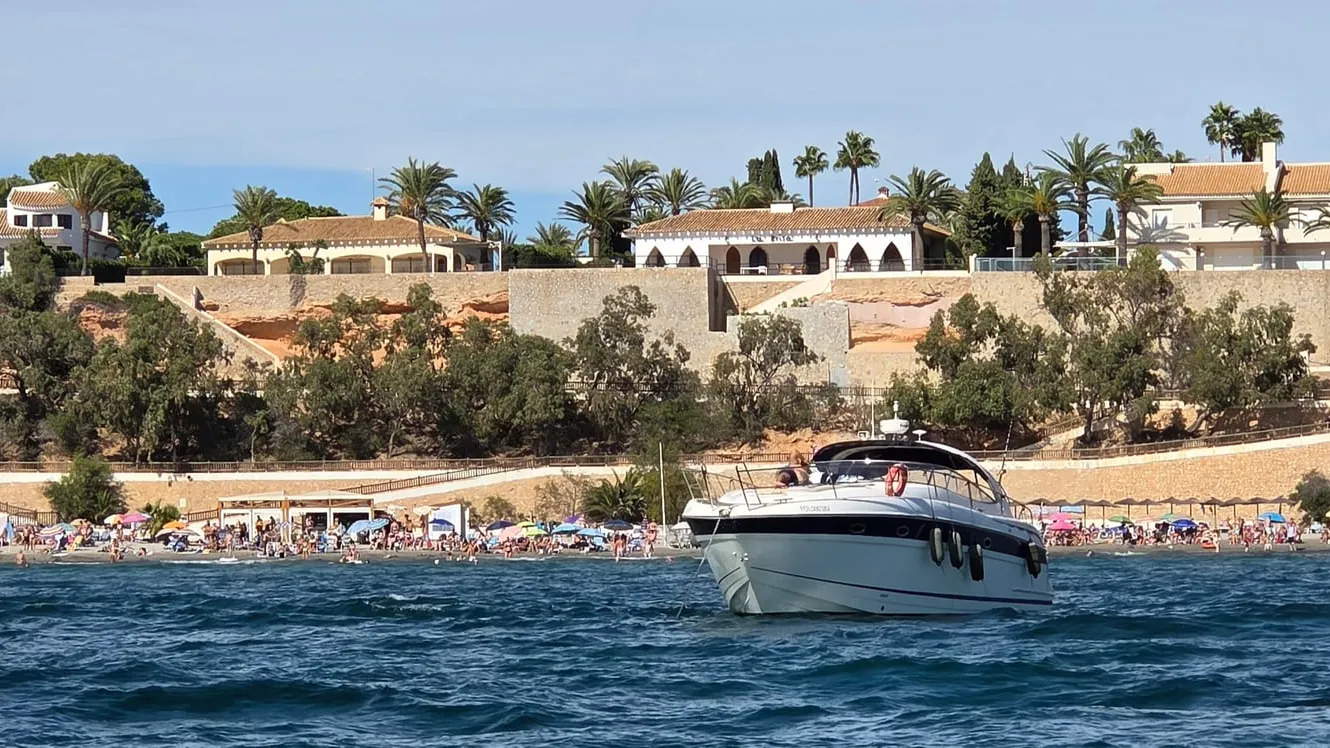 Cala Caleta sandy beach beside Cabo Roig marina