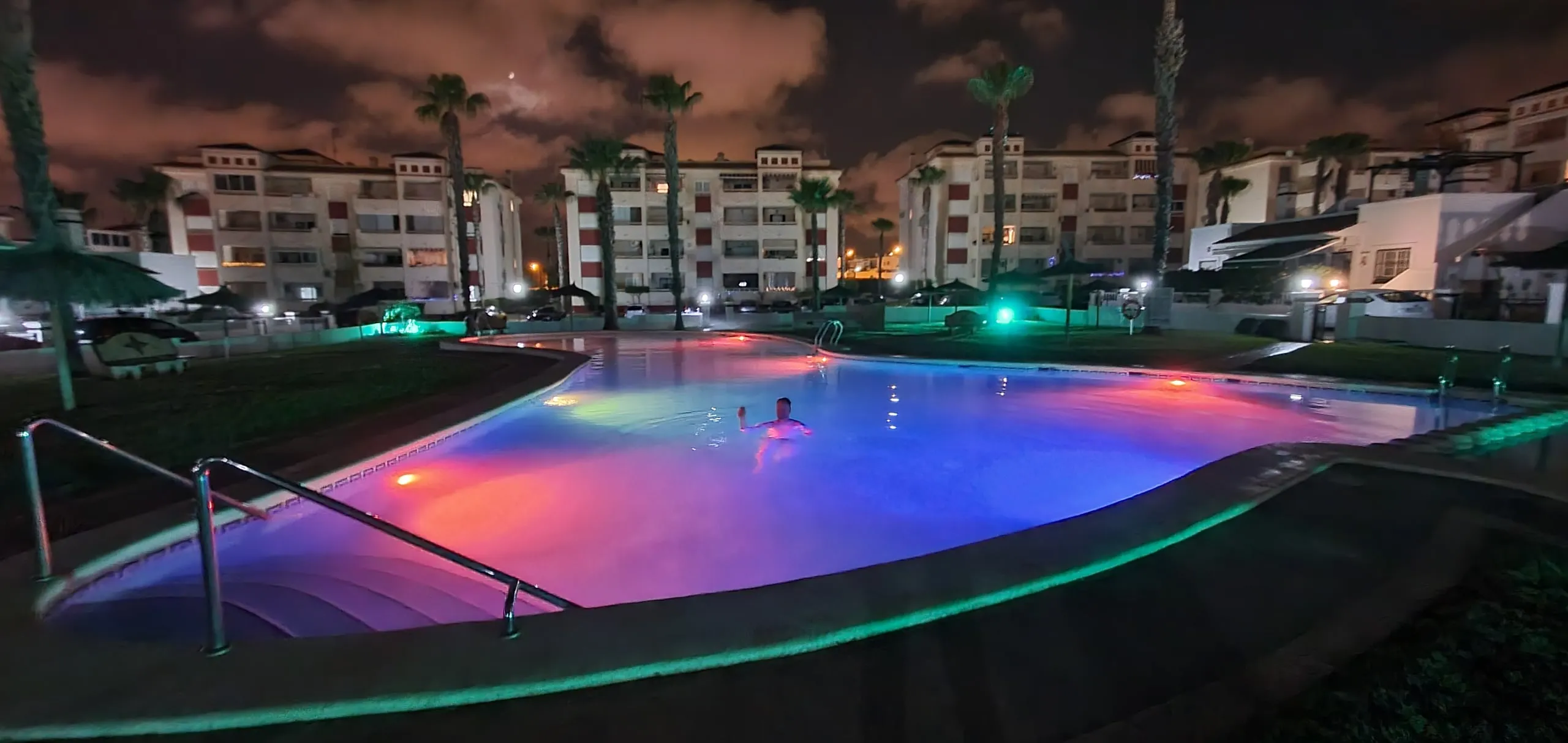 Illuminated communal pool in the evening